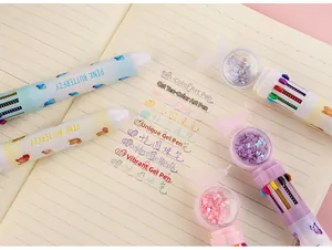 Detail of multi-color ballpoint pen featuring 10 ink colors and butterfly glitter globe cap