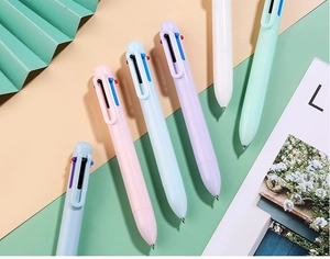 Macro detail of multi-colored retractable ballpoint pens in macaron pastel finishes