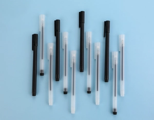 Minimalist black and translucent frosted gel pens with clips on a blue background