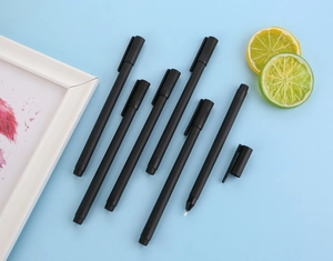 Detail view of all black matte gel pens with needle point tip on light blue background