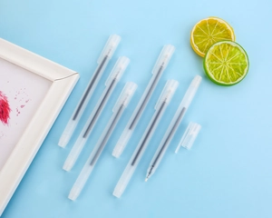 Close-up of minimalist frosted translucent gel pens with fine nib detail on blue background