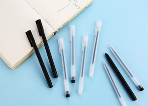 Detailed close-up of translucent frosted gel pen tips on a notebook for study