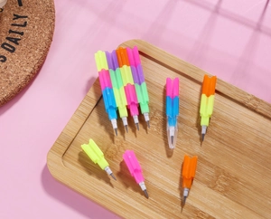 Detail of colorful stackable block pencils with graphite tips on a pink background