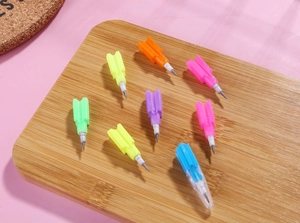 Close-up of 8 vibrant colors of stackable pencil refills on a bamboo display board
