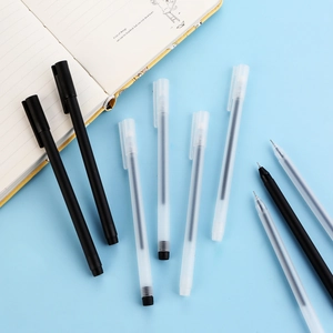Minimalist frosted gel pen set with notebooks on a bright blue desktop background
