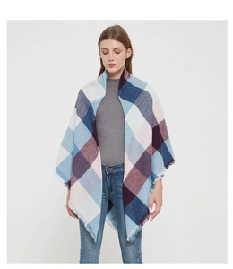 Detail of plaid scarf featuring fringed edges and soft pastel checkered weave patterns
