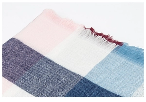 Close-up of pink and blue plaid scarf fabric showing detailed weave and frayed edges