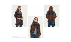 Detail of plaid scarf with soft blue and orange grid patterns and short fringe edges