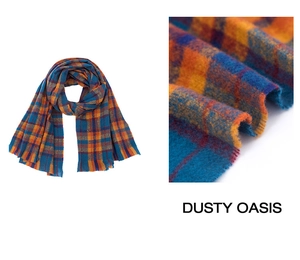 Detail of soft plaid scarf with orange and navy blue patterns and fringe edges