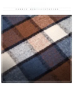 Close-up of soft plaid fabric texture with blue and brown checkered weave detail