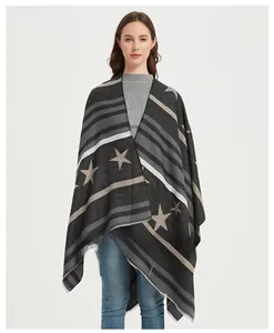 Detail of the woven star patterns and fringe edges on a winter shawl wrap for women