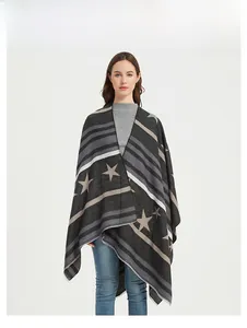 Detailed knit texture of a wide star and stripe pattern poncho shawl in charcoal grey
