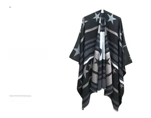 Detailed knit pattern of a star and stripe shawl with soft fringed edges in grey and black