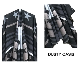 Detail of knit shawl featuring star patterns, gradient stripes and short fringe tassels