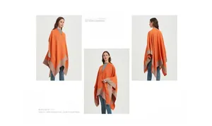 Three-view perspective of an orange knitted poncho with beige contrast trim and draped hem