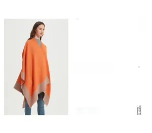 Detail of knit shawl featuring vibrant orange fabric with khaki contrast piping edge