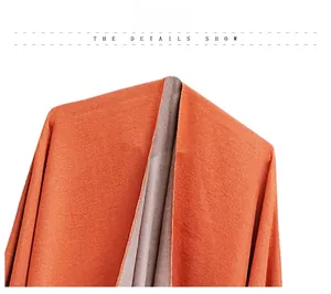 Detail showing high-quality orange and beige reversible cotton fleece poncho fabric