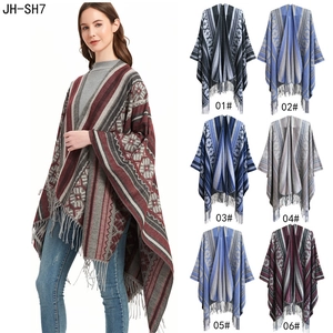 Detail of geometric jacquard knit poncho with fringe trim showing six color variants