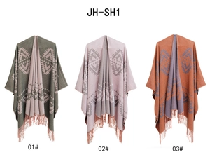 Detailed view of three knitted bohemian shawls with geometric patterns and long fringes
