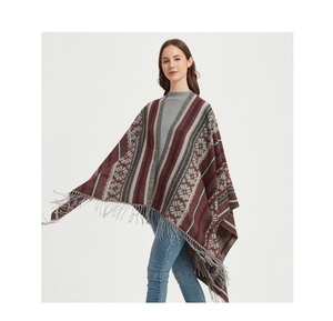 Detail of geometric jacquard pattern and long tassel fringe on a warm ethnic shawl