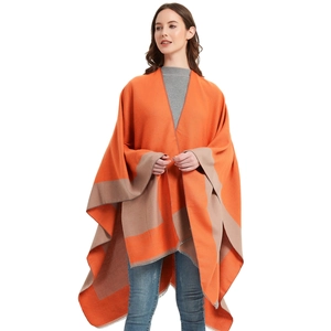Women's chic orange and beige color block poncho wrap with tassel hem details