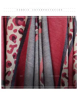 Detail of red and grey leopard print knit shawl fabric texture and tassel fringe