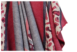 Detail of soft leopard print shawl with dark red and grey knitted patchwork fabric