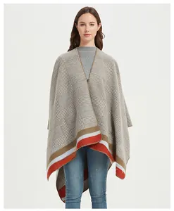 Detail of grey plaid knit shawl featuring stylish red and white striped hem accents