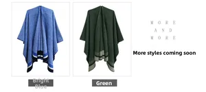 Detail view of acrylic plaid ponchos in bright blue and forest green with striped hems
