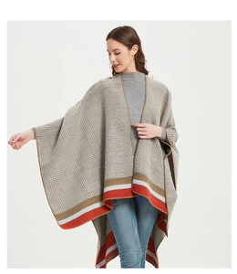 Detail of checkered knit poncho with color-block stripes and side slit drape style