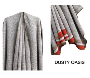 Detail of grey knitted shawl with orange contrast stripes and chunky texture