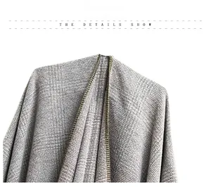 Detail shot of light grey knitted shawl featuring premium olive green border piping