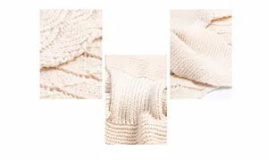 Détail de la petite cape en tricot ajouré blanc crème avec motif de tissage ondulé épais