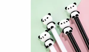 Close-up of cute panda pens on pink and green background with 3D silicone panda toppers