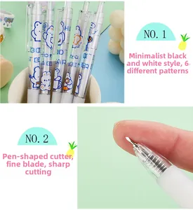 Close-up of retractable pen-shaped craft knife with cute blue cartoon bear pattern
