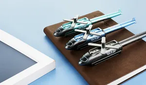 Detailed close-up of helicopter-shaped pens with propellers on leather notebook
