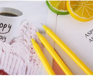 Detailed view of three yellow fine point gel pens with precision needle tips for writing