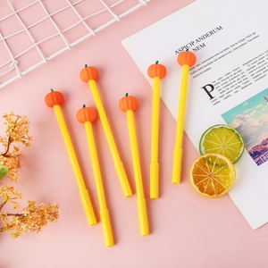 Set of six cute pumpkin gel pens with orange toppers on a decorative background