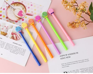 Detailed view of 6 colorful lollipop gel pens with cute bowknots on pink background