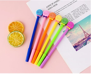 Close-up of a 6-piece set of colorful lollipop gel pens with bows on a pink desktop