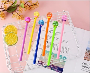 Set of six colorful lollipop-shaped gel pens with ribbon bows in a white storage basket