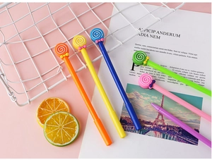 Macro detail of six colorful lollipop gel pens with cute bow ties on a pink background