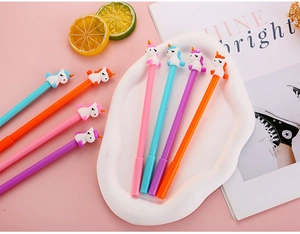 Detail view of colorful cartoon unicorn gel pens in pink, blue, purple, and orange hues