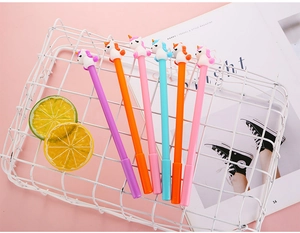 Close-up of creative cartoon unicorn pens in a white basket with a soft pink background