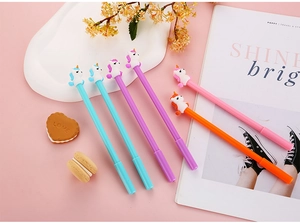 Set of six colorful unicorn pens on pink background with stylish lifestyle props