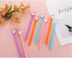 Detailed view of colorful cartoon unicorn pens with soft rubber tops on pink background