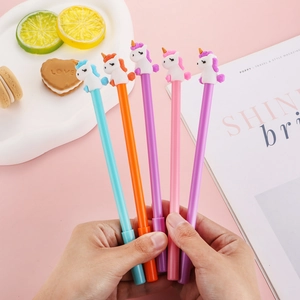 Set of 5 cartoon unicorn gel pens in assorted colors held against a pink background