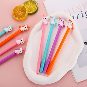 Cartoon unicorn gel pens set in pink blue purple and orange colors on a ceramic tray