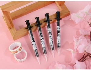 Detail view of syringe-shaped creative gel pens with cartoon graphics and piston design