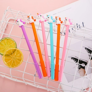Set of six colorful unicorn gel pens with cute 3D toppers in a white decorative basket